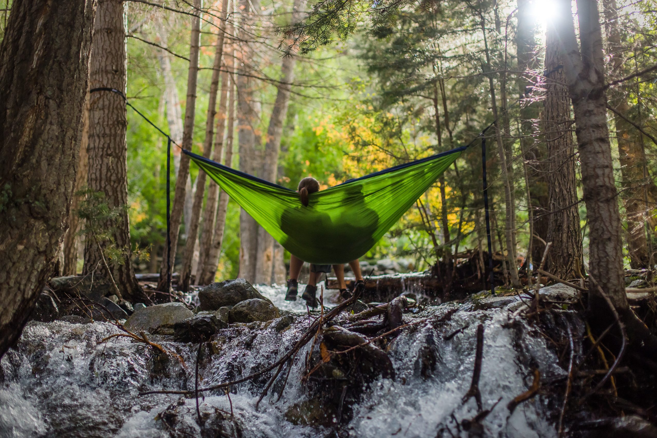 two person on green mesh hammock outdoor